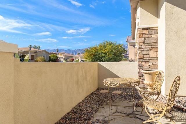 view of yard featuring a mountain view and a balcony