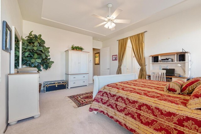 bedroom with ceiling fan and light carpet