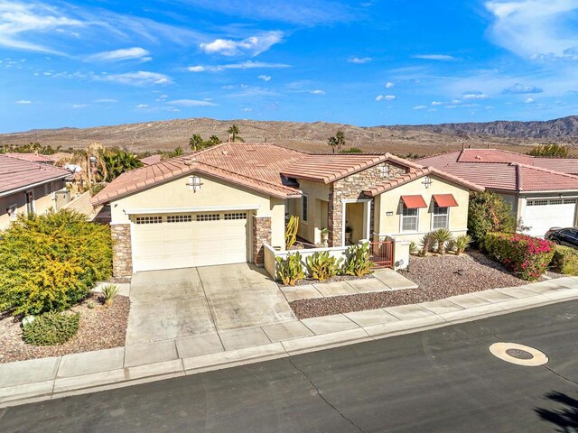 view of front of house with a mountain view and a garage