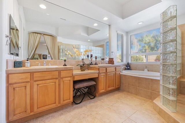 bathroom with tile patterned floors, separate shower and tub, and vanity