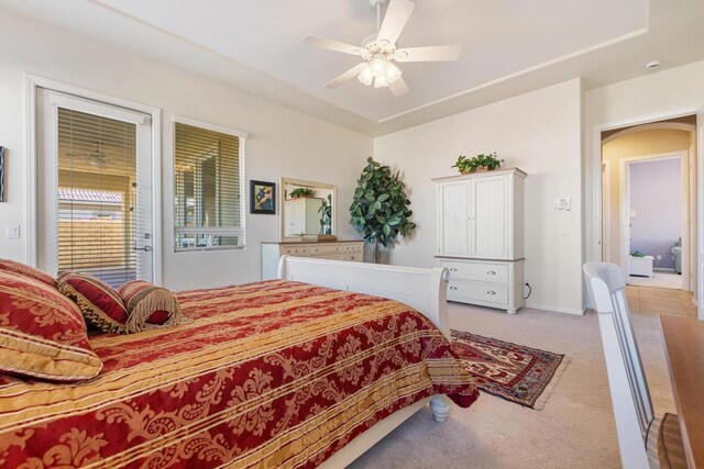 bedroom with ceiling fan and light carpet