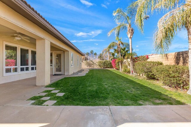 view of yard with ceiling fan and a patio area