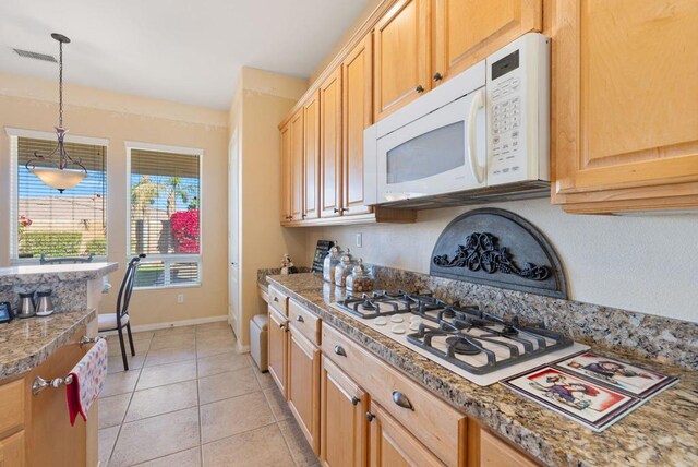 kitchen with pendant lighting, light tile patterned floors, white appliances, and light brown cabinets