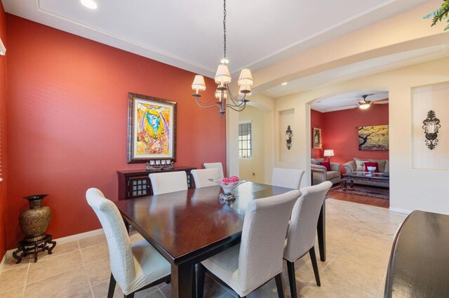 dining space featuring ceiling fan with notable chandelier