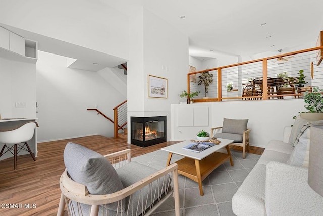 living room featuring a multi sided fireplace and hardwood / wood-style floors