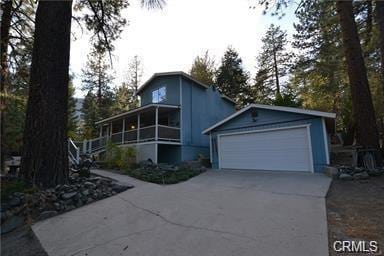 view of front of home featuring a sunroom and a garage