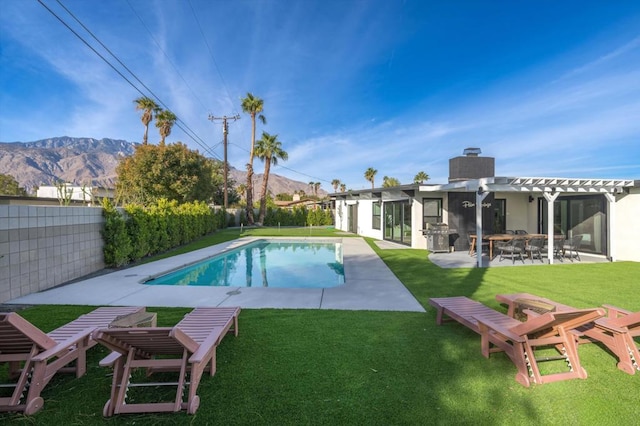 view of swimming pool with a mountain view, a yard, a patio, and a pergola