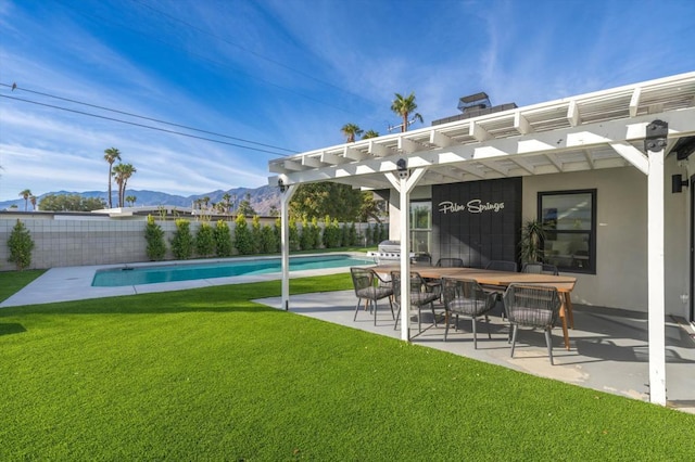 view of yard with a fenced in pool, a pergola, a mountain view, and a patio