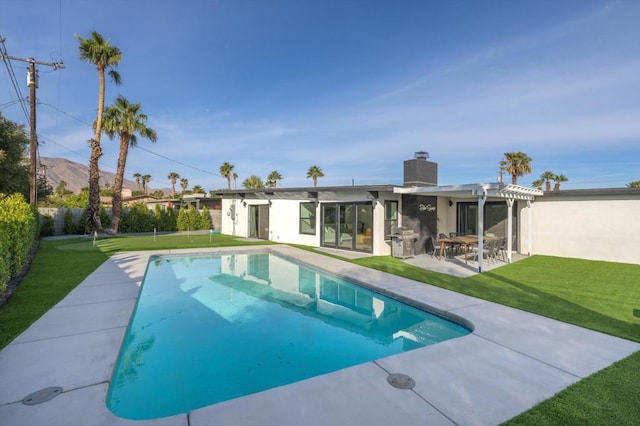 view of swimming pool with a pergola, a patio, and a yard