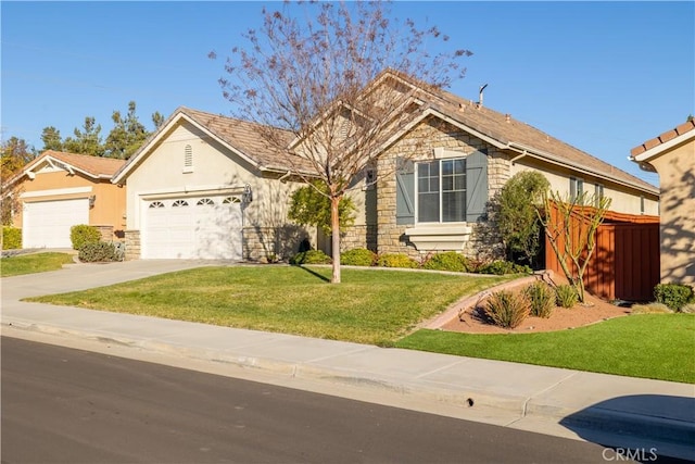 view of front of property with a front yard and a garage