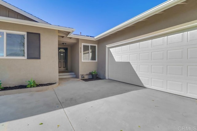 view of exterior entry with a garage