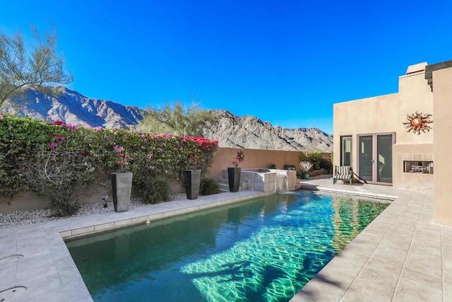 view of pool featuring a mountain view and a patio area