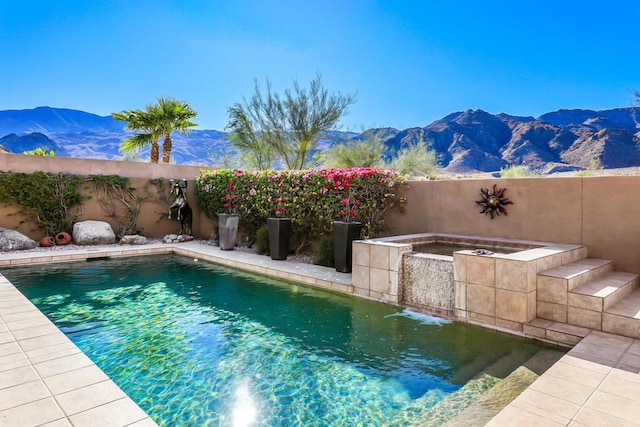 view of pool featuring a mountain view and a jacuzzi