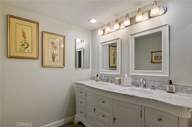 bathroom with a textured ceiling and vanity