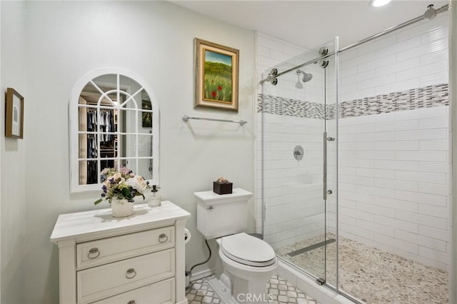 full bath featuring vanity, a shower stall, and toilet