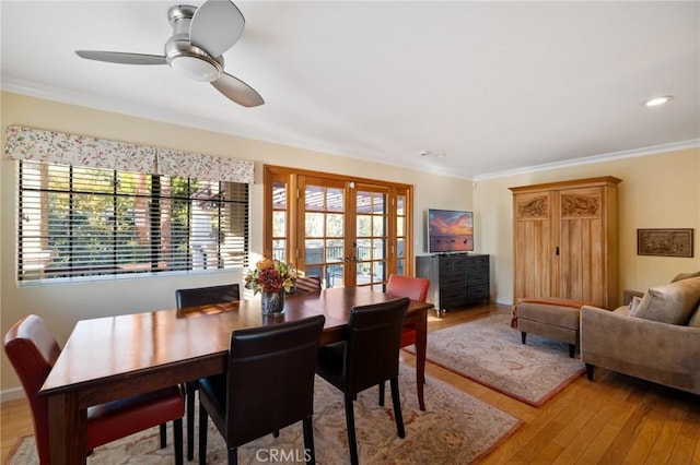 dining space featuring ornamental molding, french doors, ceiling fan, and light hardwood / wood-style floors