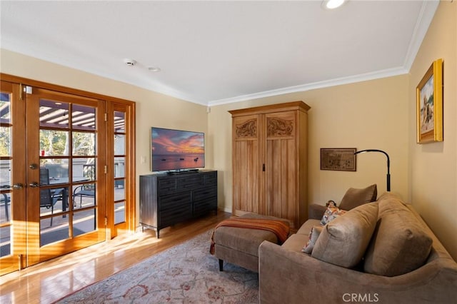 living area with french doors, crown molding, and wood-type flooring