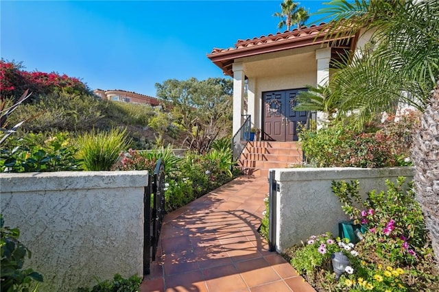 view of home's exterior with a fenced front yard, a gate, and stucco siding