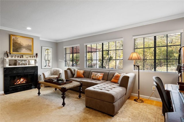 living area featuring crown molding, recessed lighting, a high end fireplace, wood finished floors, and baseboards