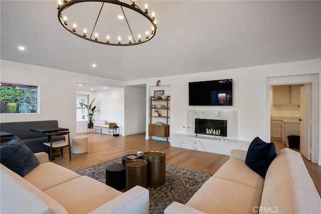 living room with a fireplace and light wood-type flooring