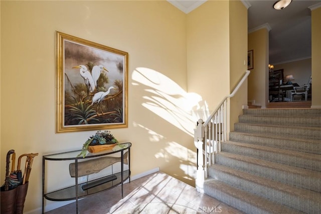 stairs featuring baseboards, crown molding, and tile patterned floors