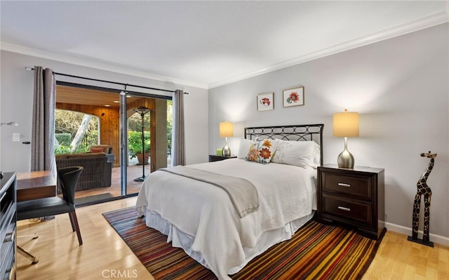 bedroom featuring light hardwood / wood-style flooring, crown molding, and access to exterior