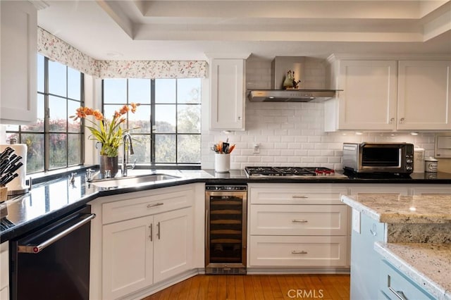 kitchen featuring white cabinets, dishwashing machine, wine cooler, stainless steel gas stovetop, and a sink