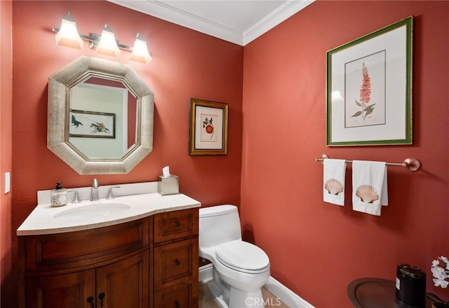 bathroom with baseboards, crown molding, vanity, and toilet