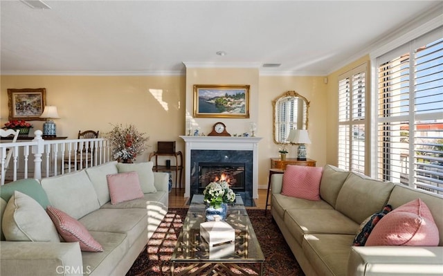 living room with visible vents, a high end fireplace, and crown molding