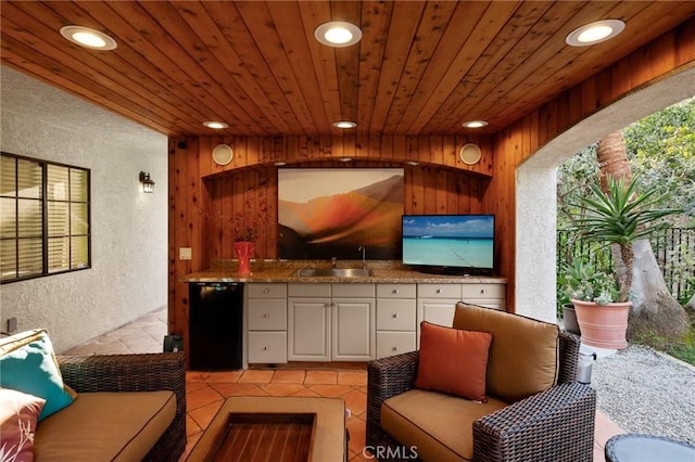 exterior space featuring recessed lighting, wood walls, wood ceiling, and a textured wall