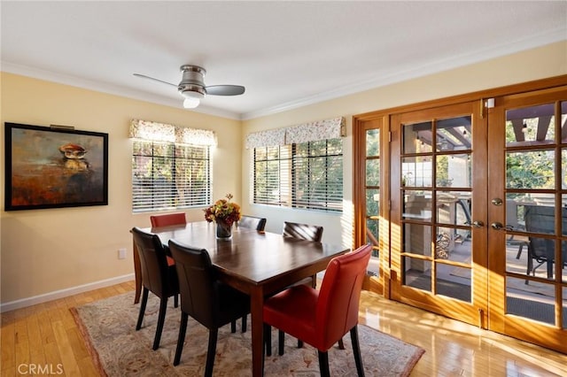 dining room featuring ceiling fan, light hardwood / wood-style floors, french doors, and crown molding