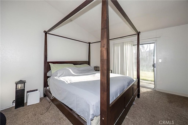 bedroom with access to exterior, dark carpet, and lofted ceiling