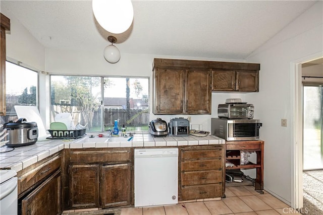 kitchen featuring tile countertops, dark brown cabinetry, dishwasher, and light tile patterned floors