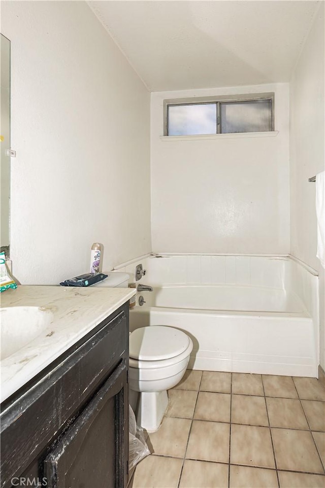 bathroom with tile patterned floors, vanity, a bath, and toilet