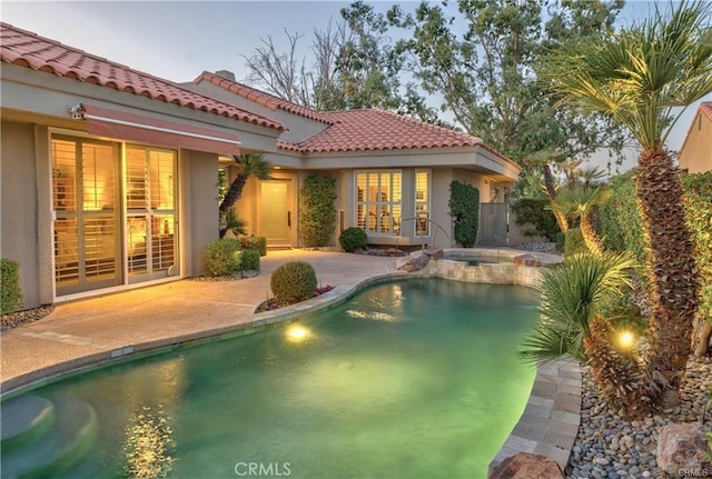 view of pool with a pool with connected hot tub and a patio