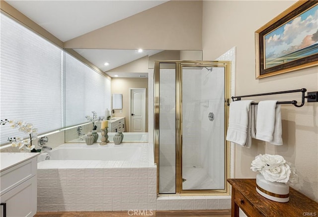 full bath featuring vaulted ceiling, a stall shower, vanity, and a bath