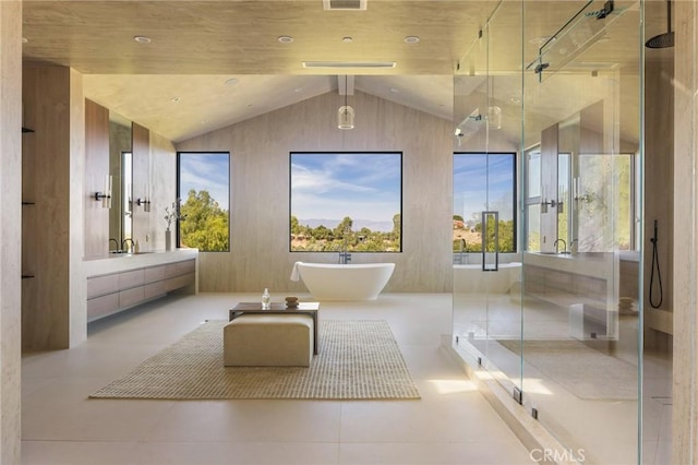 bathroom with shower with separate bathtub, vanity, and lofted ceiling