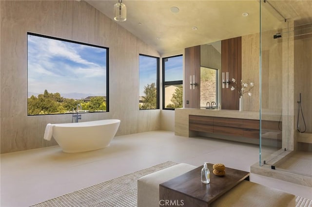 bathroom featuring vanity, separate shower and tub, lofted ceiling, and a wealth of natural light