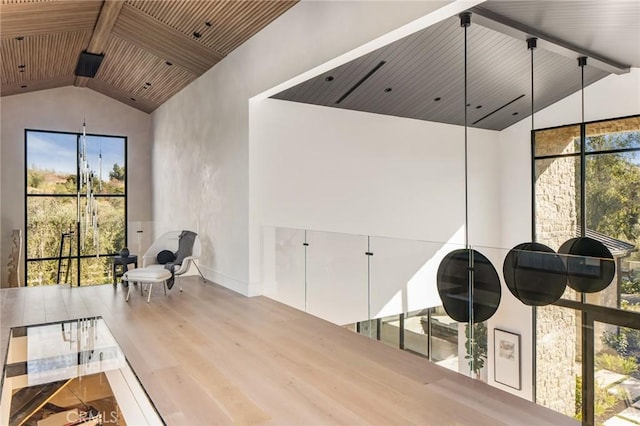 interior space featuring hardwood / wood-style floors and lofted ceiling with beams