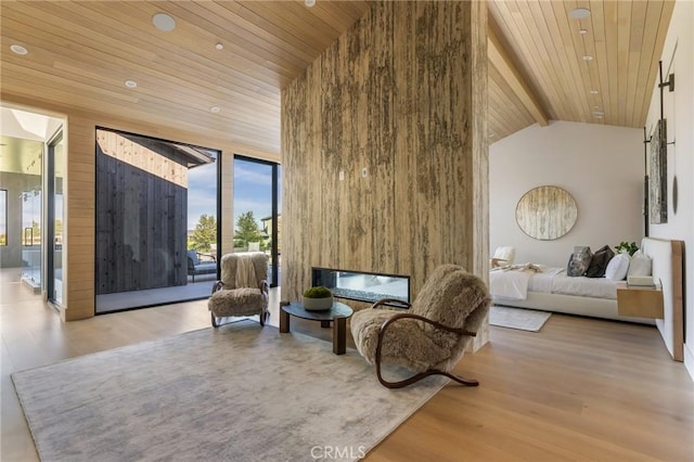 sitting room with high vaulted ceiling, light hardwood / wood-style flooring, wooden ceiling, and wood walls