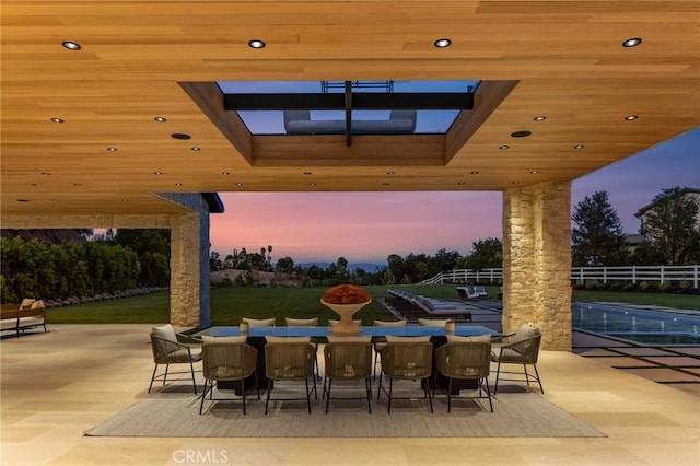 patio terrace at dusk with a swimming pool