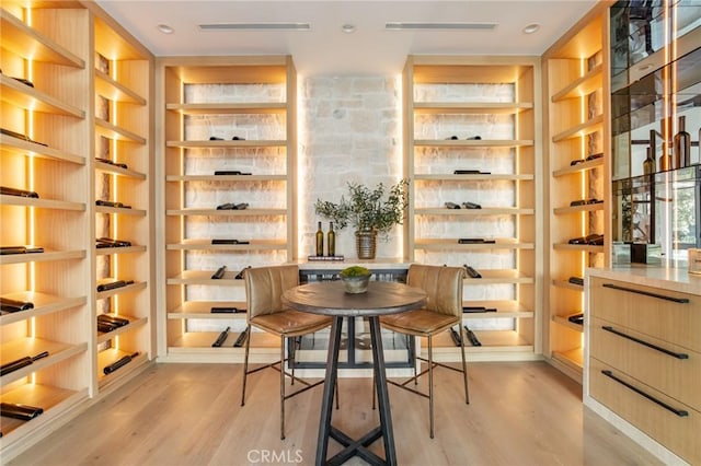 wine room with light hardwood / wood-style flooring