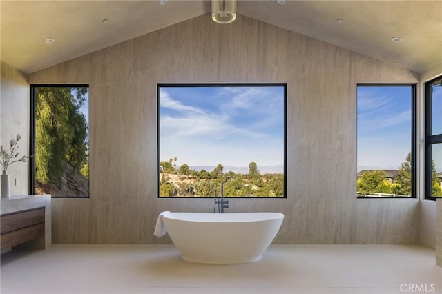 bathroom with a bath and lofted ceiling