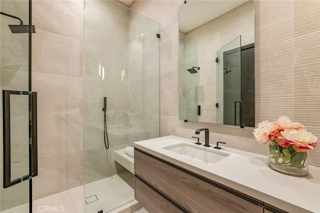 bathroom featuring vanity and a shower with shower door