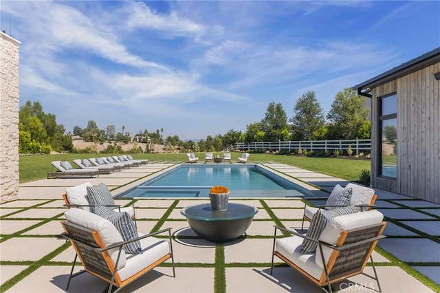 view of swimming pool featuring a lawn and a patio