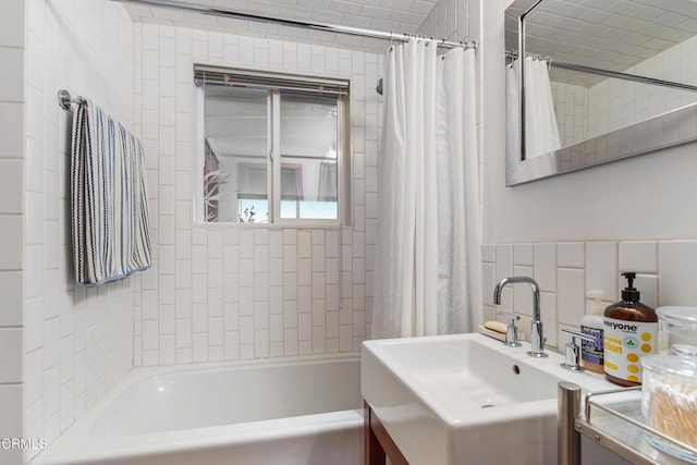 bathroom featuring vanity, shower / tub combo with curtain, and backsplash