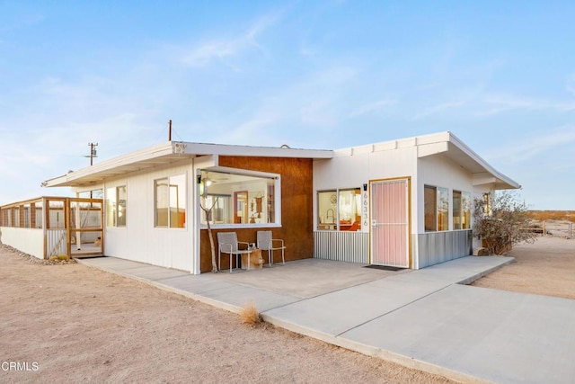 exterior space featuring a sunroom and a patio area