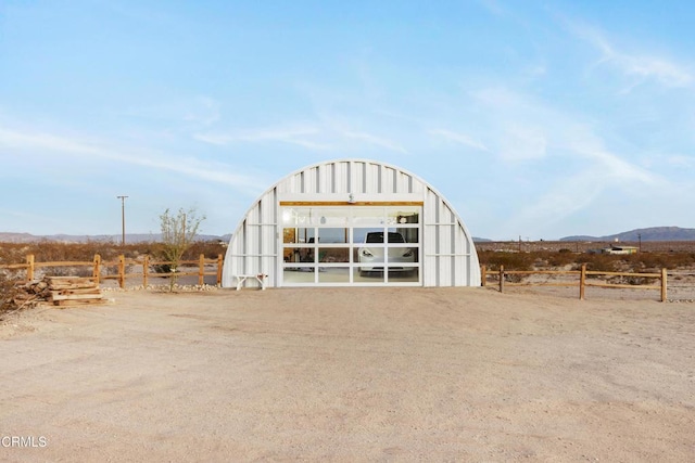 view of outbuilding with a mountain view and a rural view