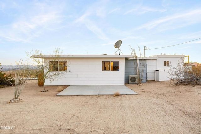 back of property with a patio area and ac unit