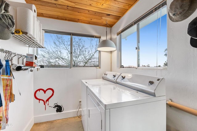 washroom featuring wood ceiling and washer and dryer